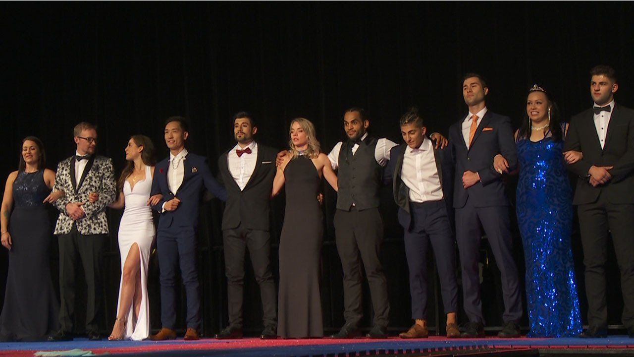 A group of people standing next to each other on a stage.
