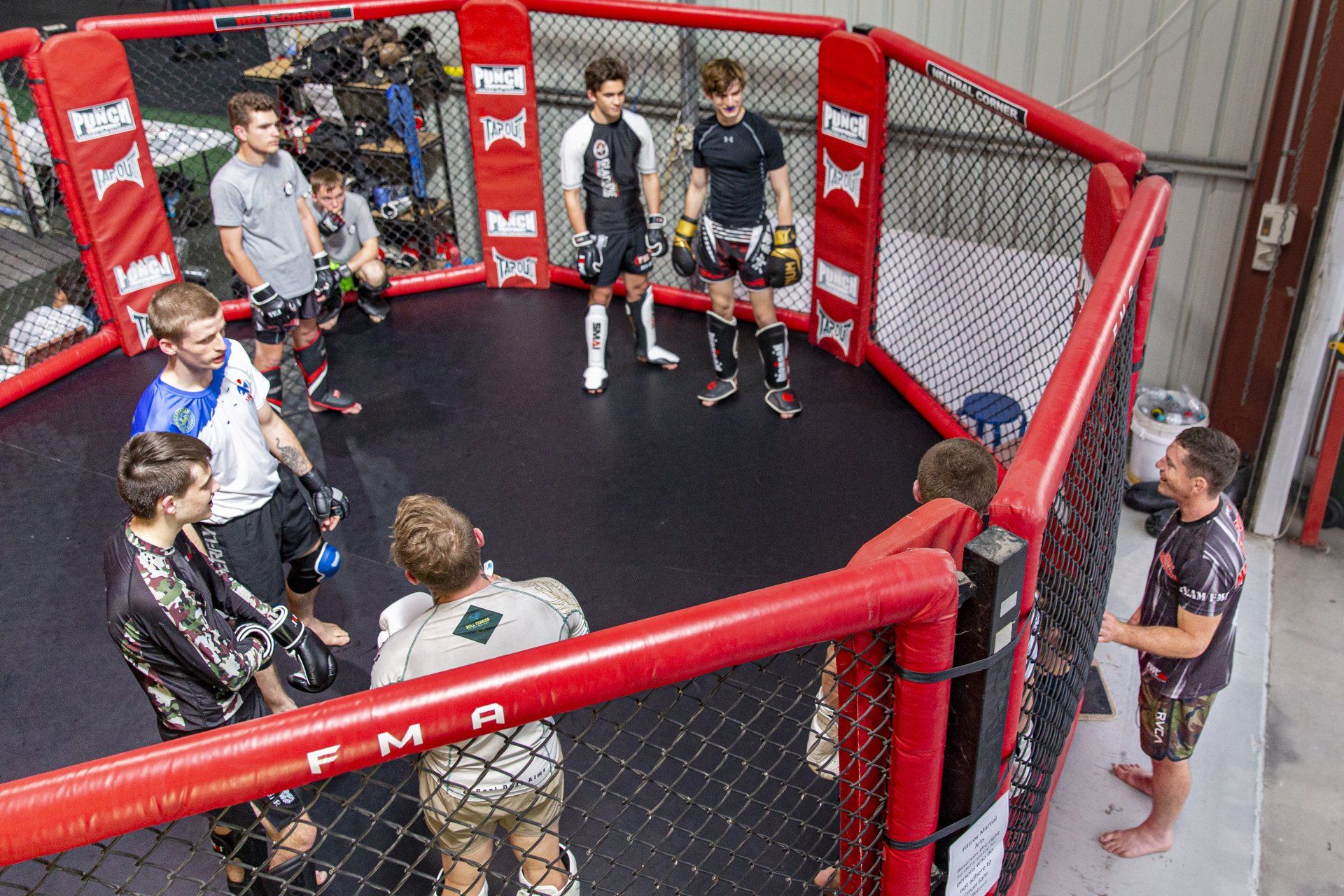 A group of men are standing in a boxing ring.