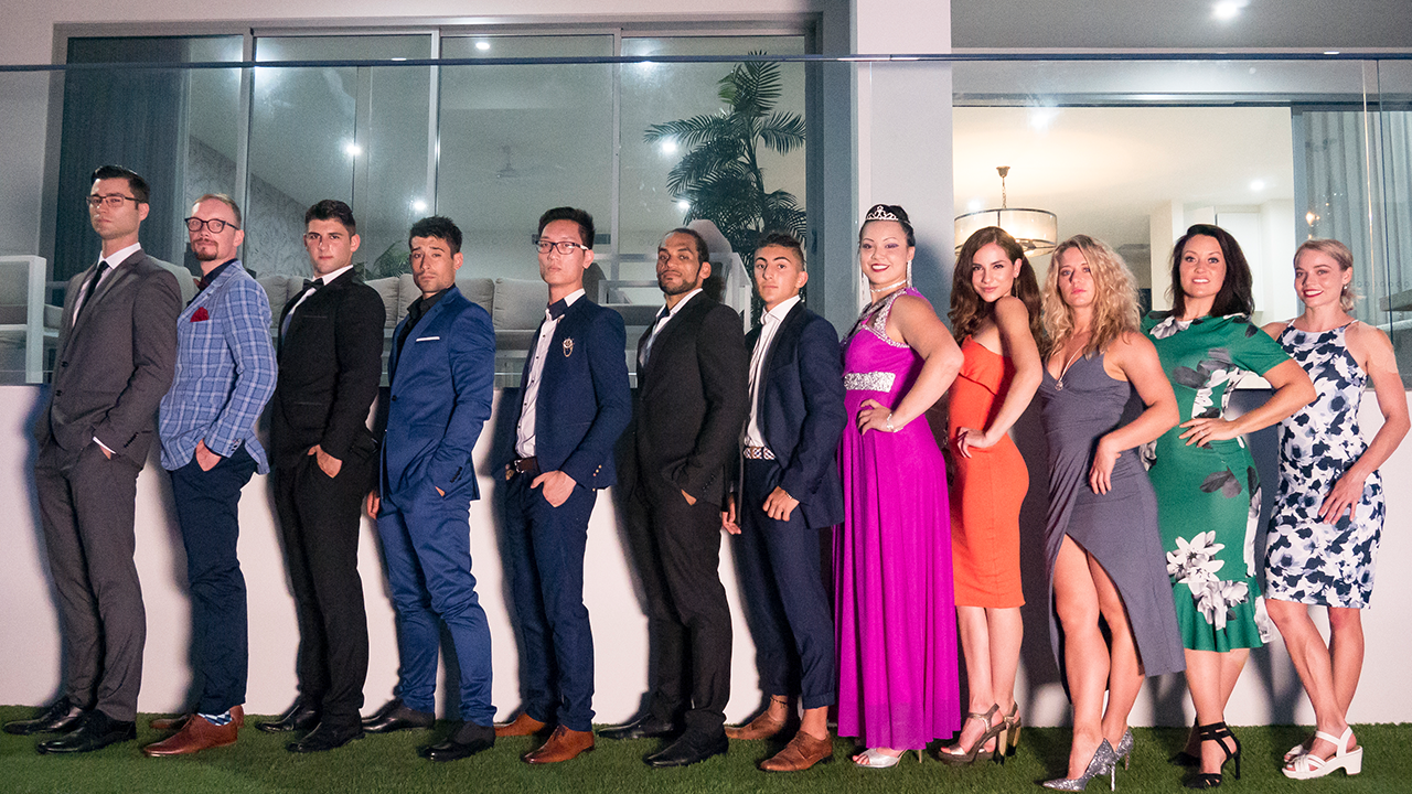 A group of people standing next to each other in front of a building.