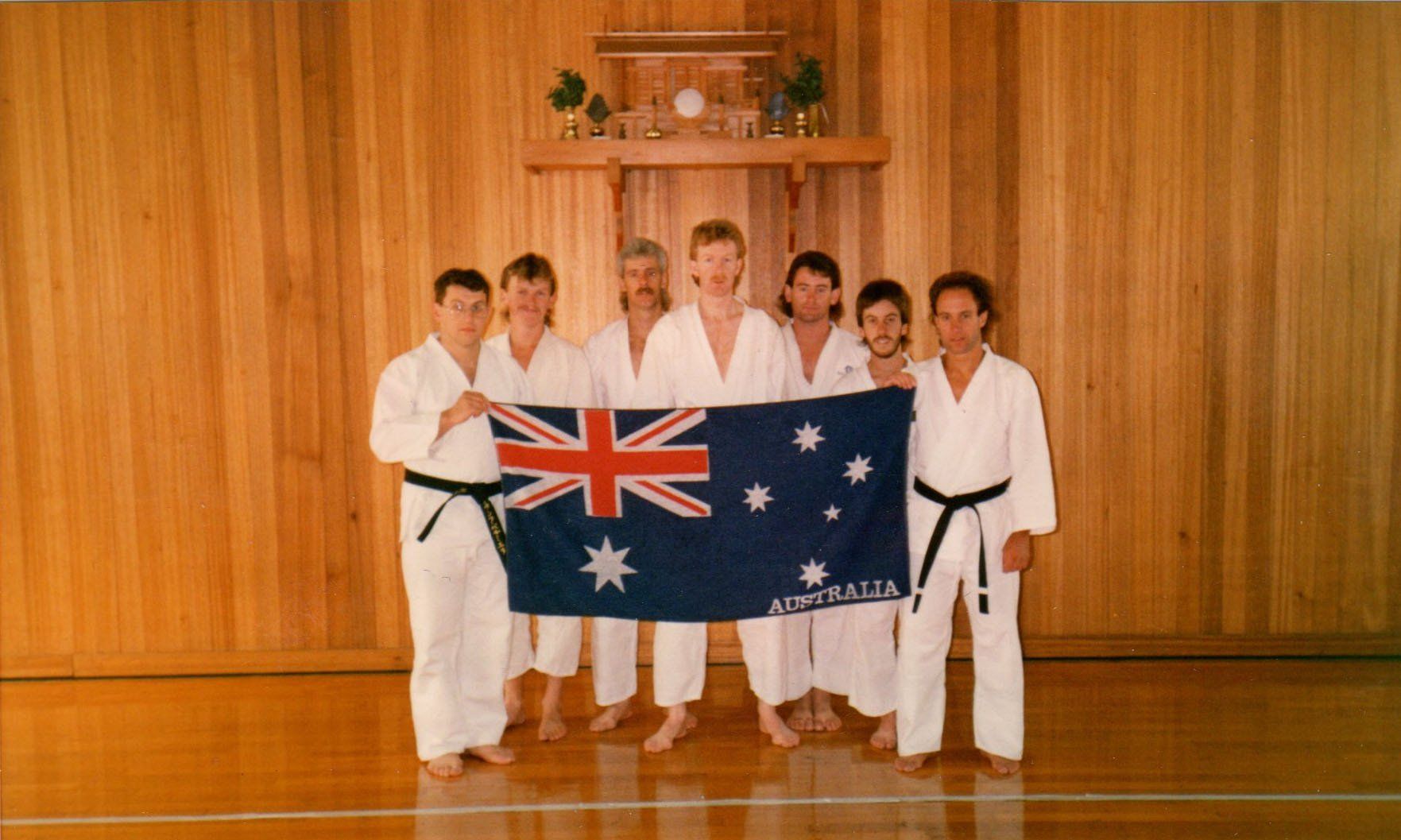 A group of people holding an australian flag