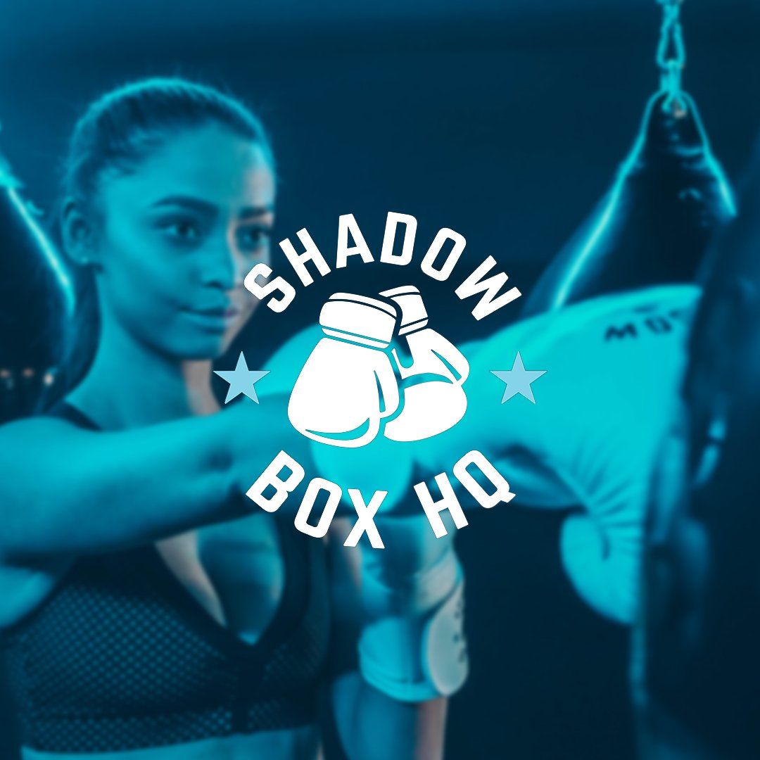 A woman wearing boxing gloves stands in front of a shadow box logo
