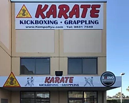A building with a sign that says karate kickboxing grappling