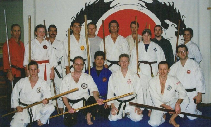 A group of martial arts fighters pose for a photo