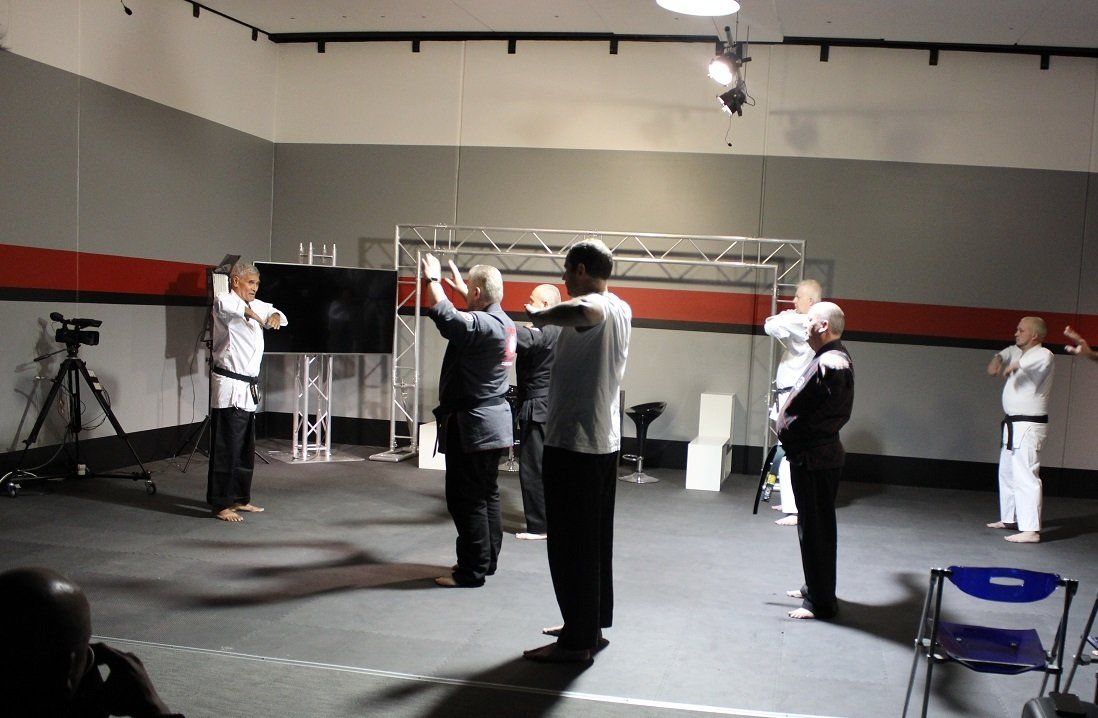 A group of men are standing in a dark room