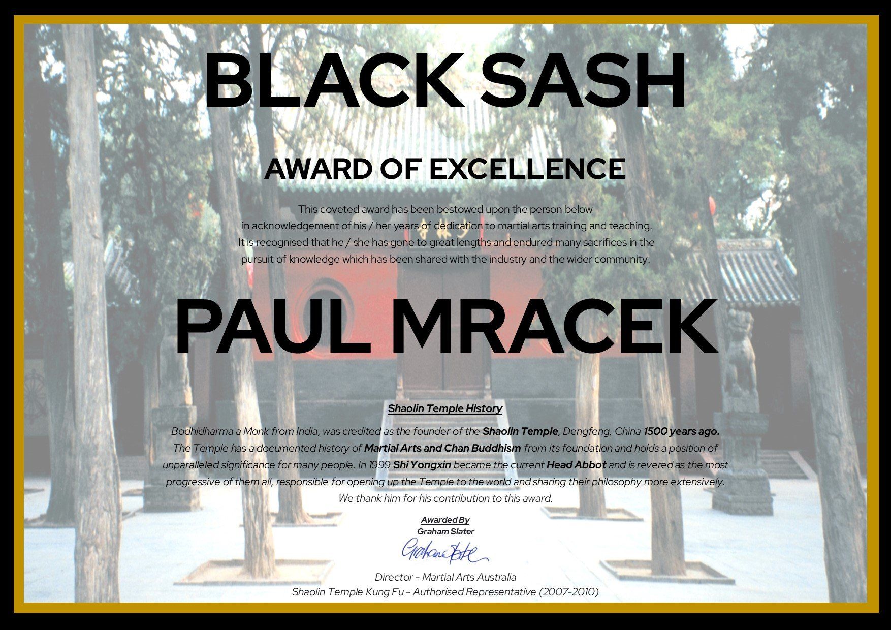 A black sash award of excellence is being presented to paul mracek
