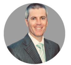 A man in a suit and tie is smiling in a circle