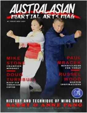 A man and a woman are on the cover of a martial arts magazine