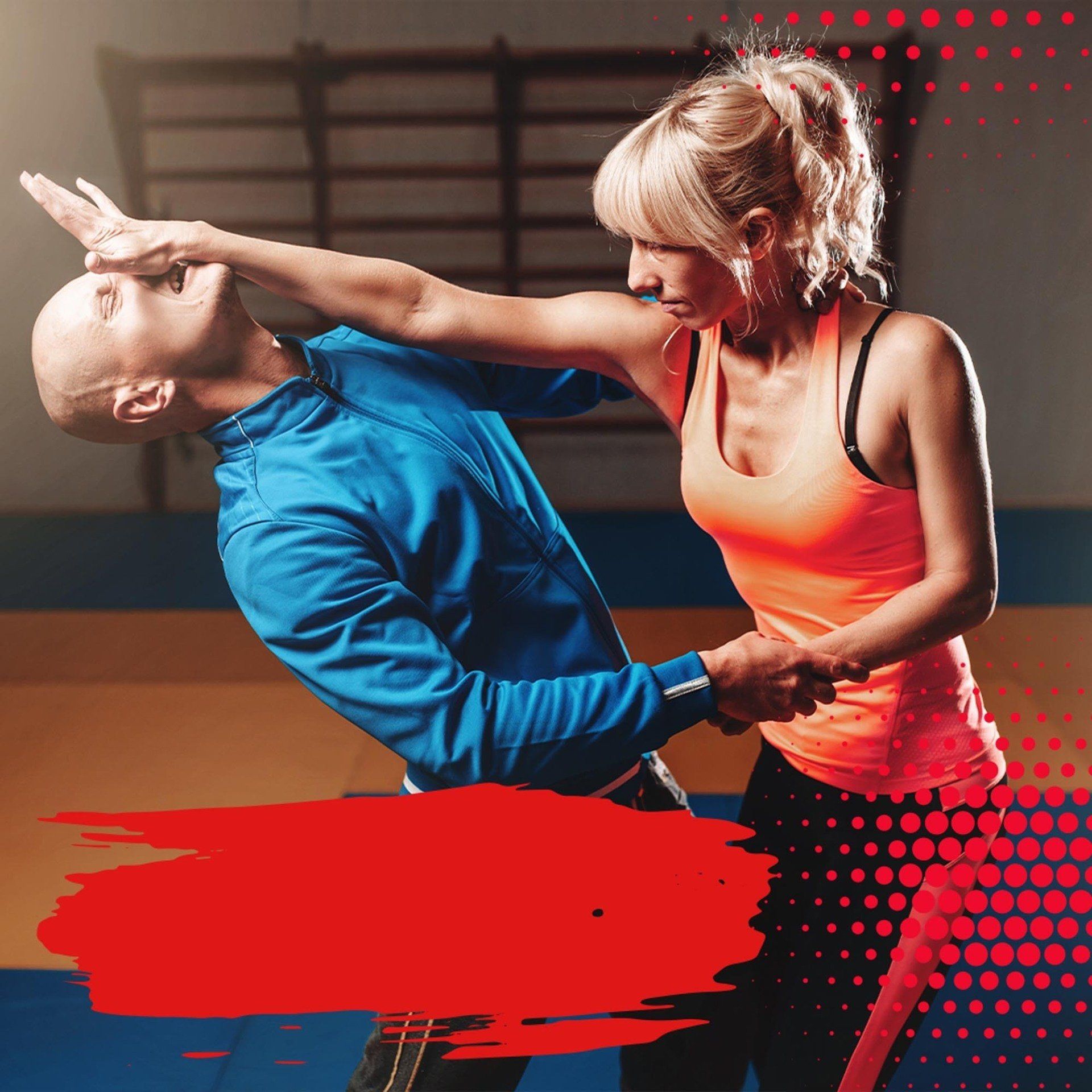 A man and a woman are practicing self defense in a gym.