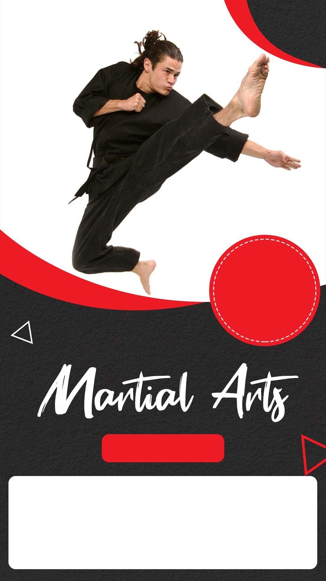 A man in a black karate uniform is kicking in the air.