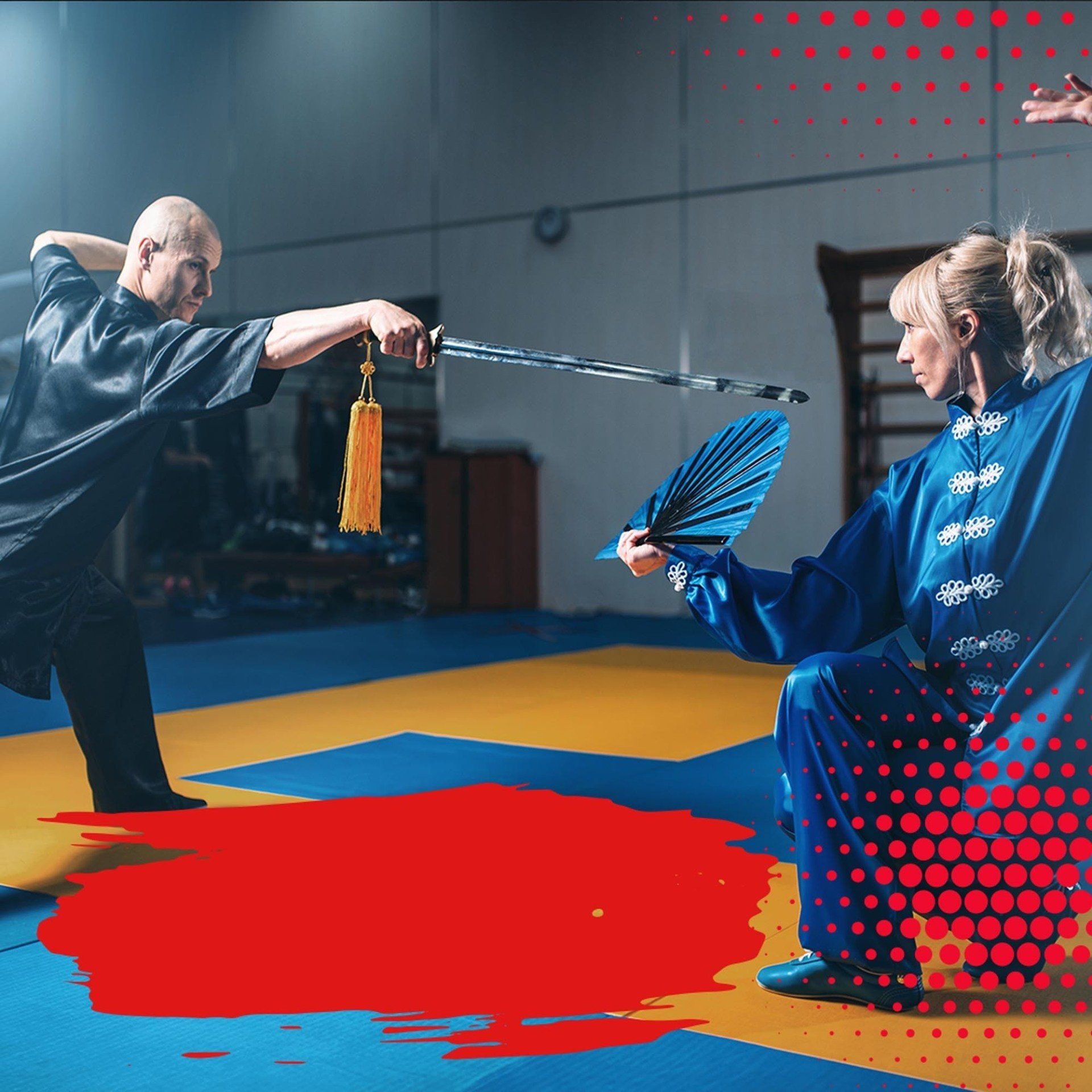 A man and a woman are practicing martial arts in a gym.