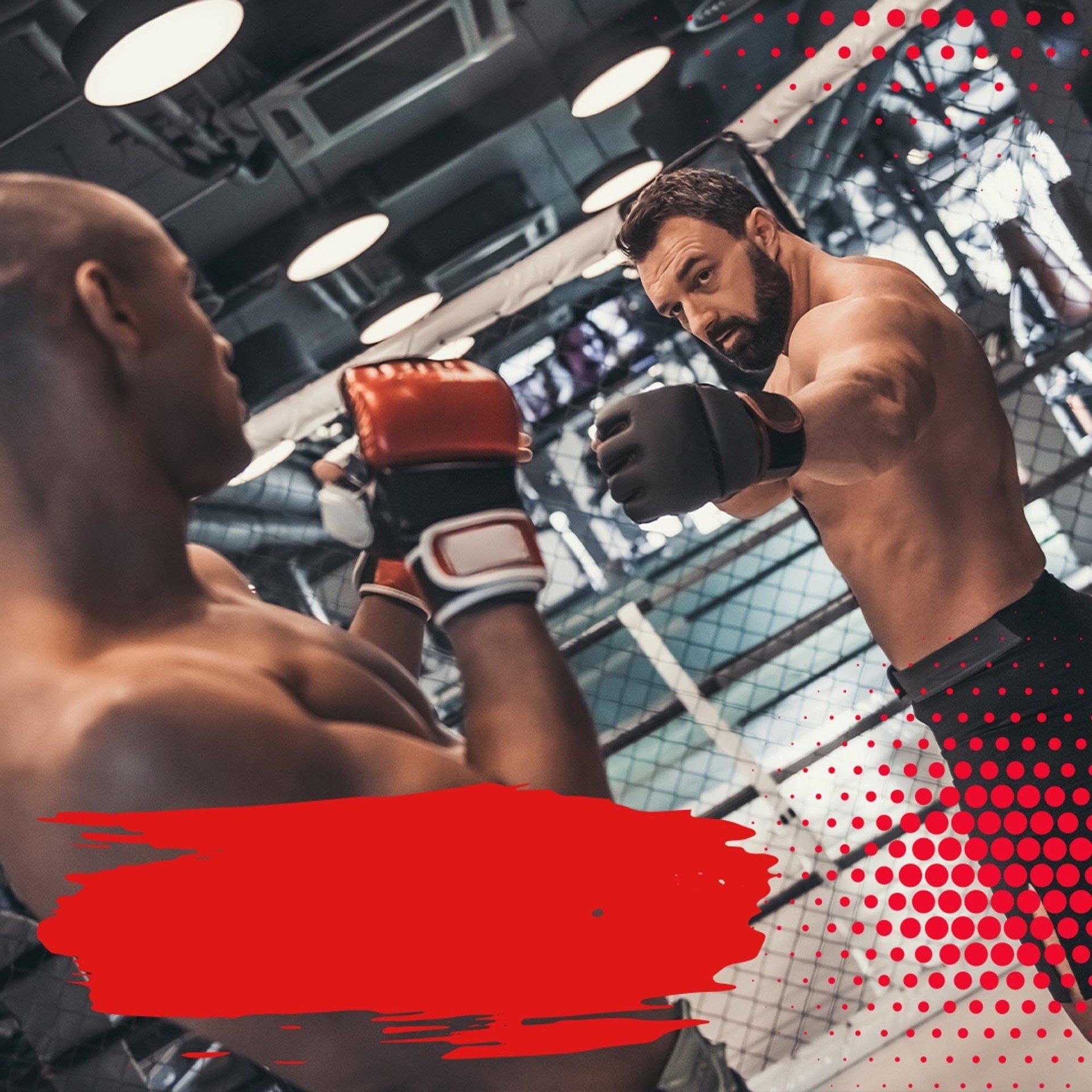 Two men are boxing in a ring in a gym.
