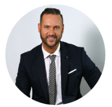 A man in a suit and tie is smiling in a circle