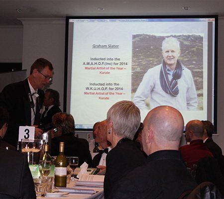 A group of people sitting at a table with a sign that says 3