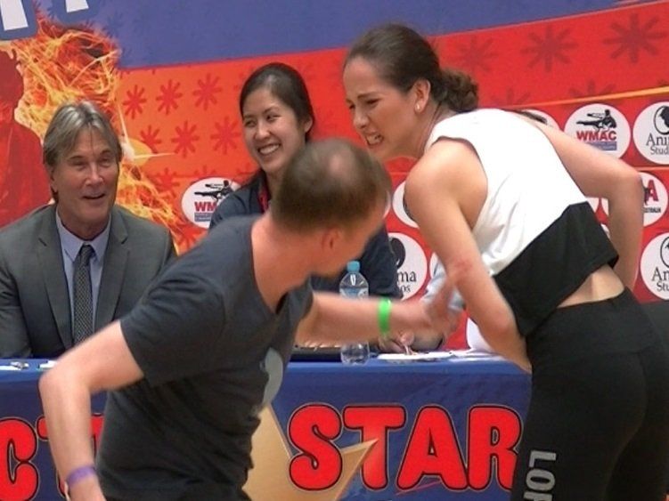 A man and a woman are wrestling in front of a star sign