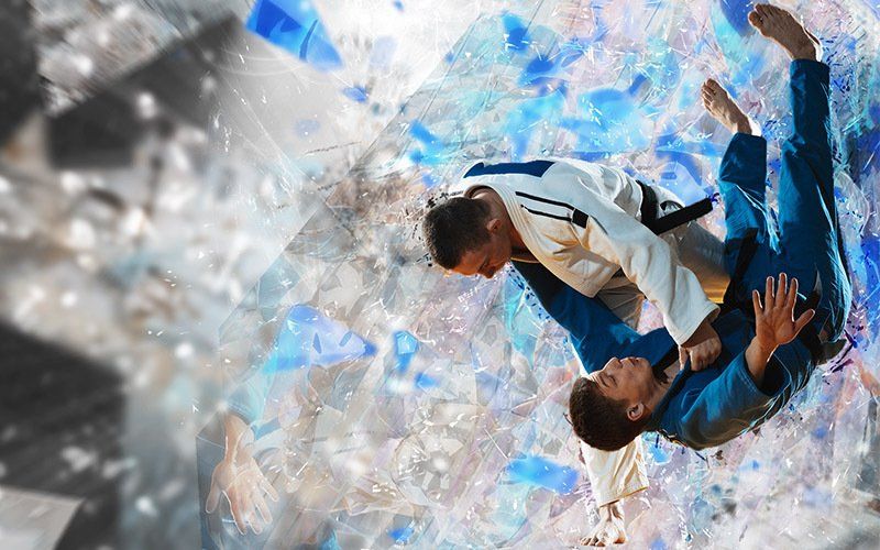 Two men are fighting each other in a judo match.