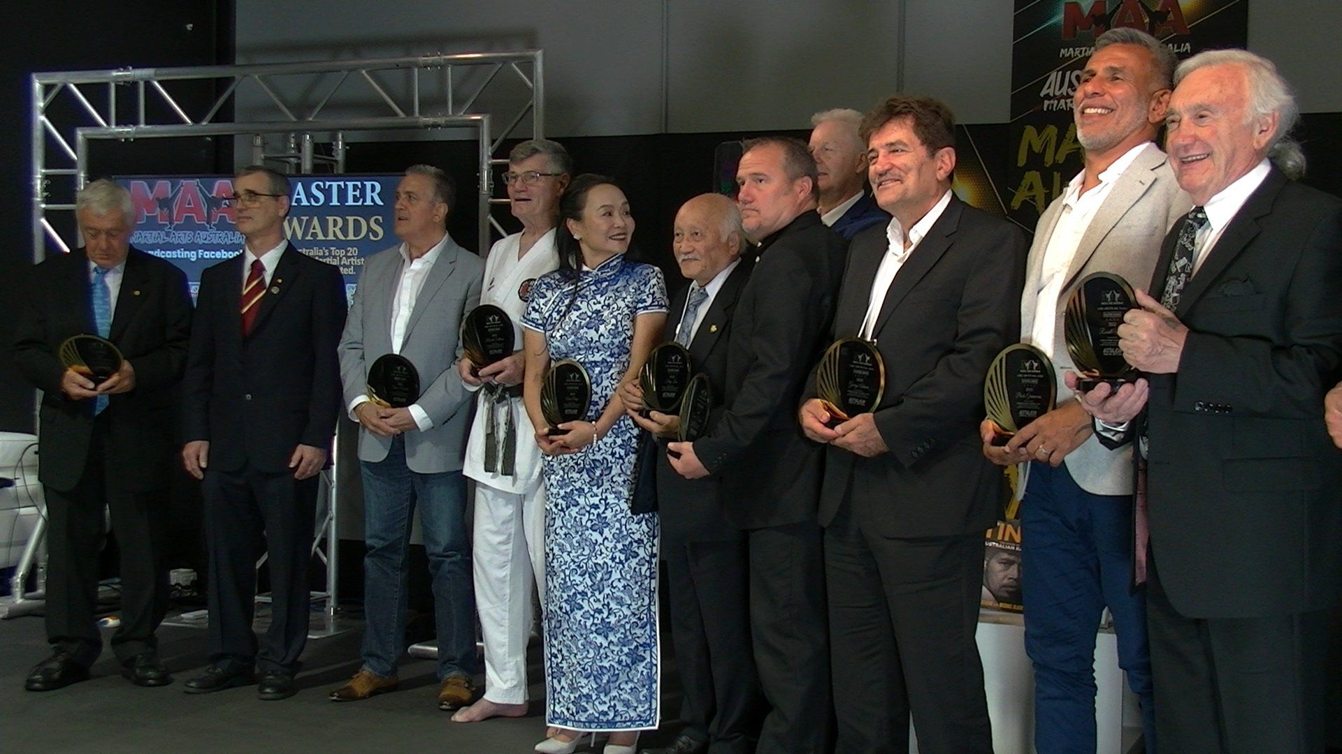A group of people standing in front of a sign that says masters