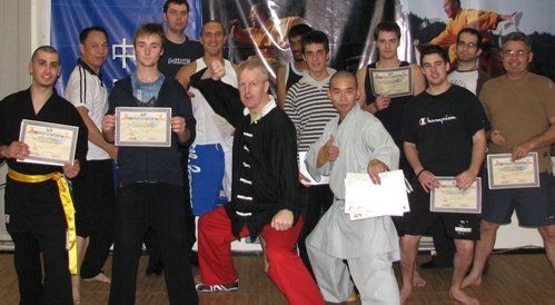 A group of young men are posing for a picture holding certificates