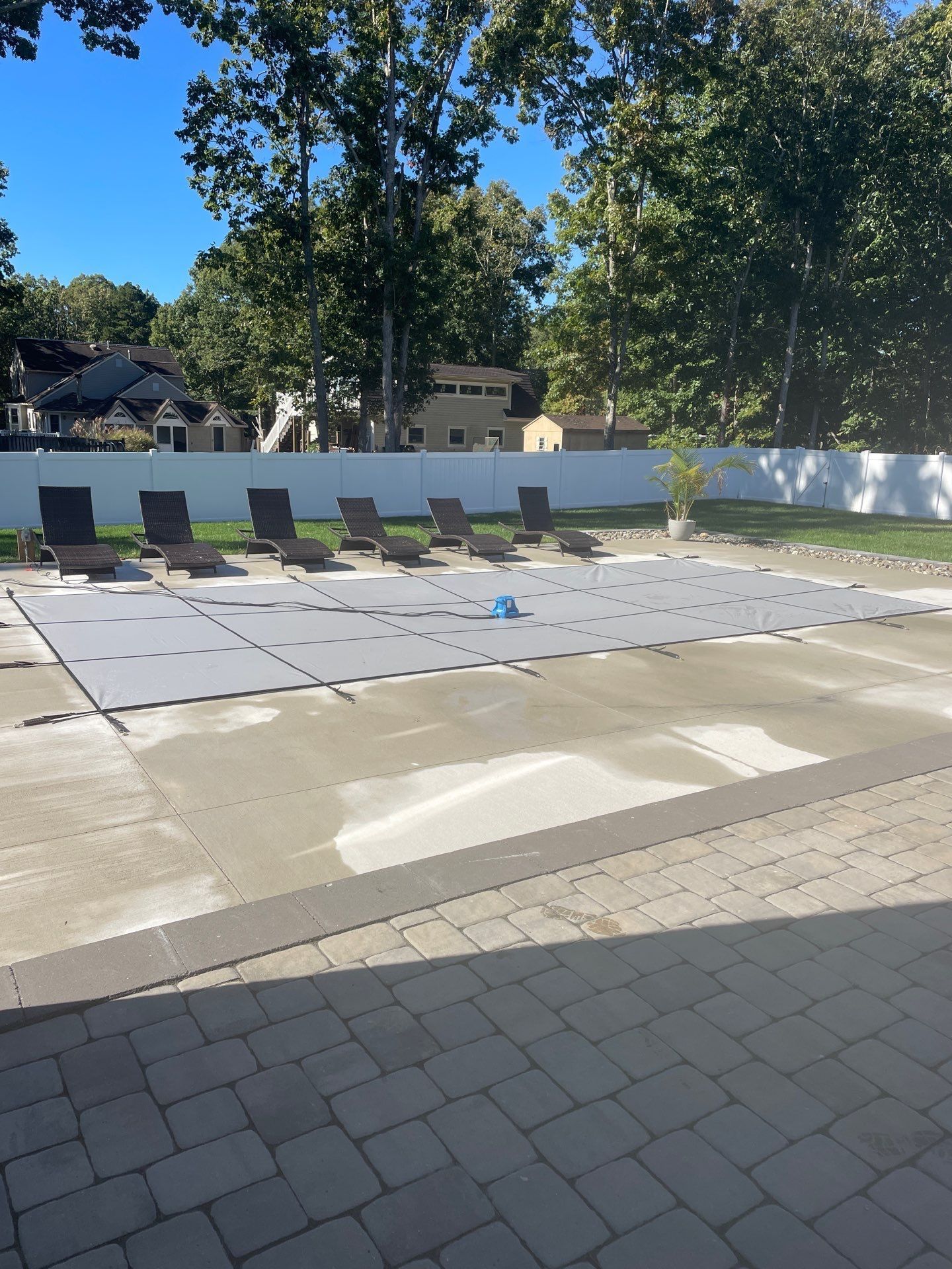 A large swimming pool with a lot of chairs around it