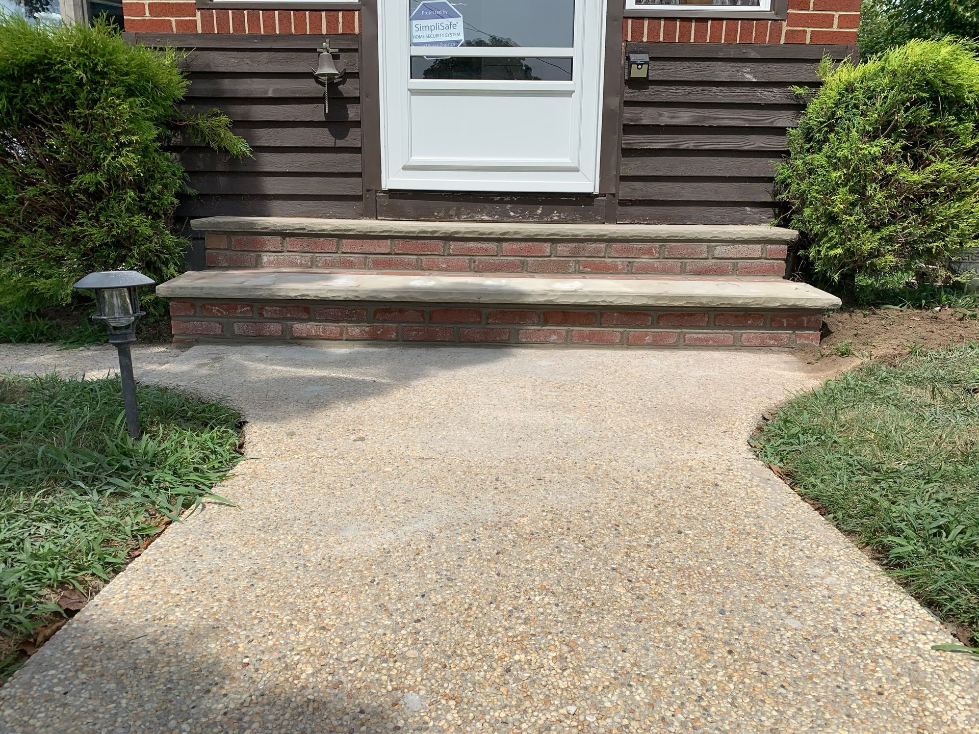 A walkway leading to the front door of a house