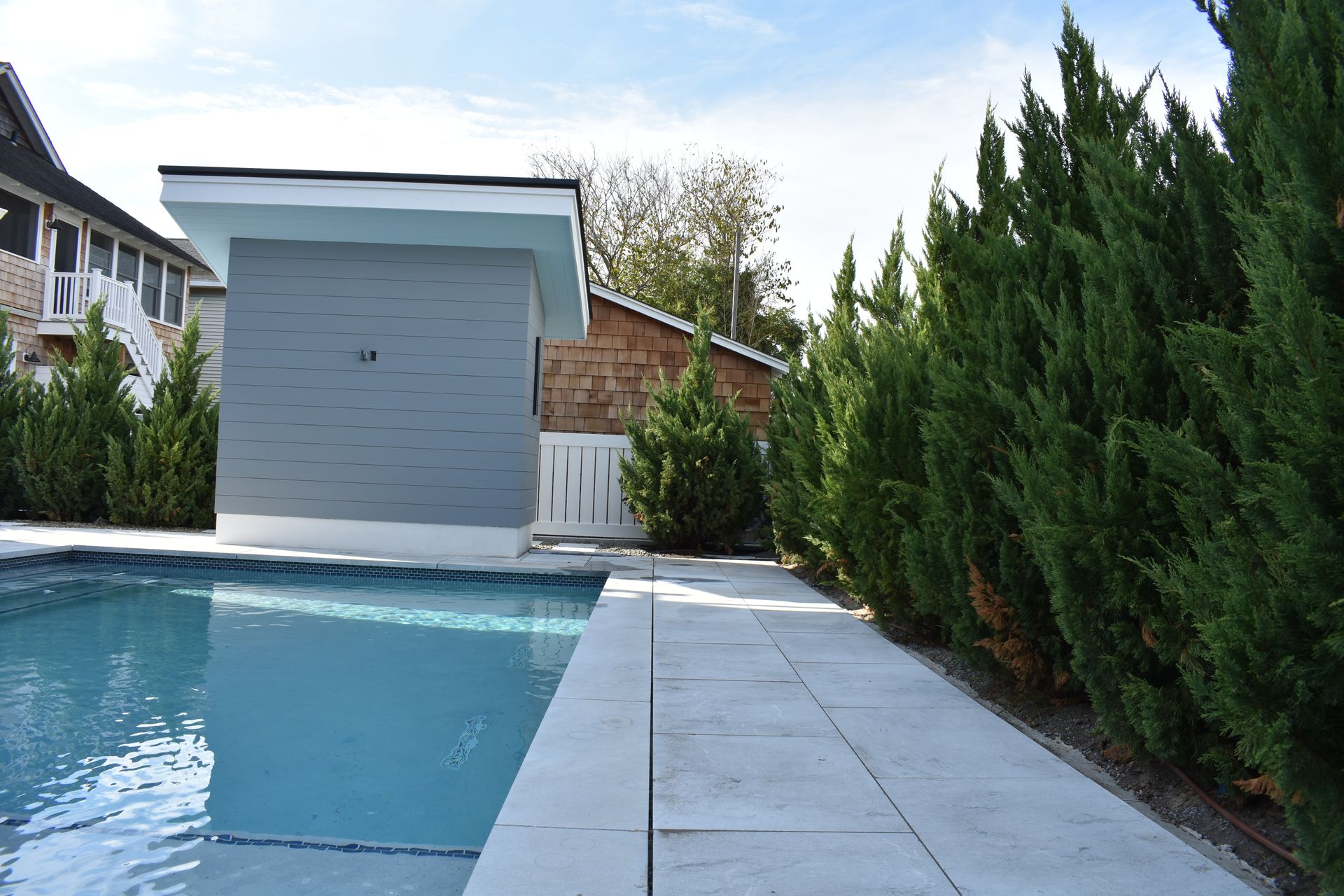 A large swimming pool with a shed in the background