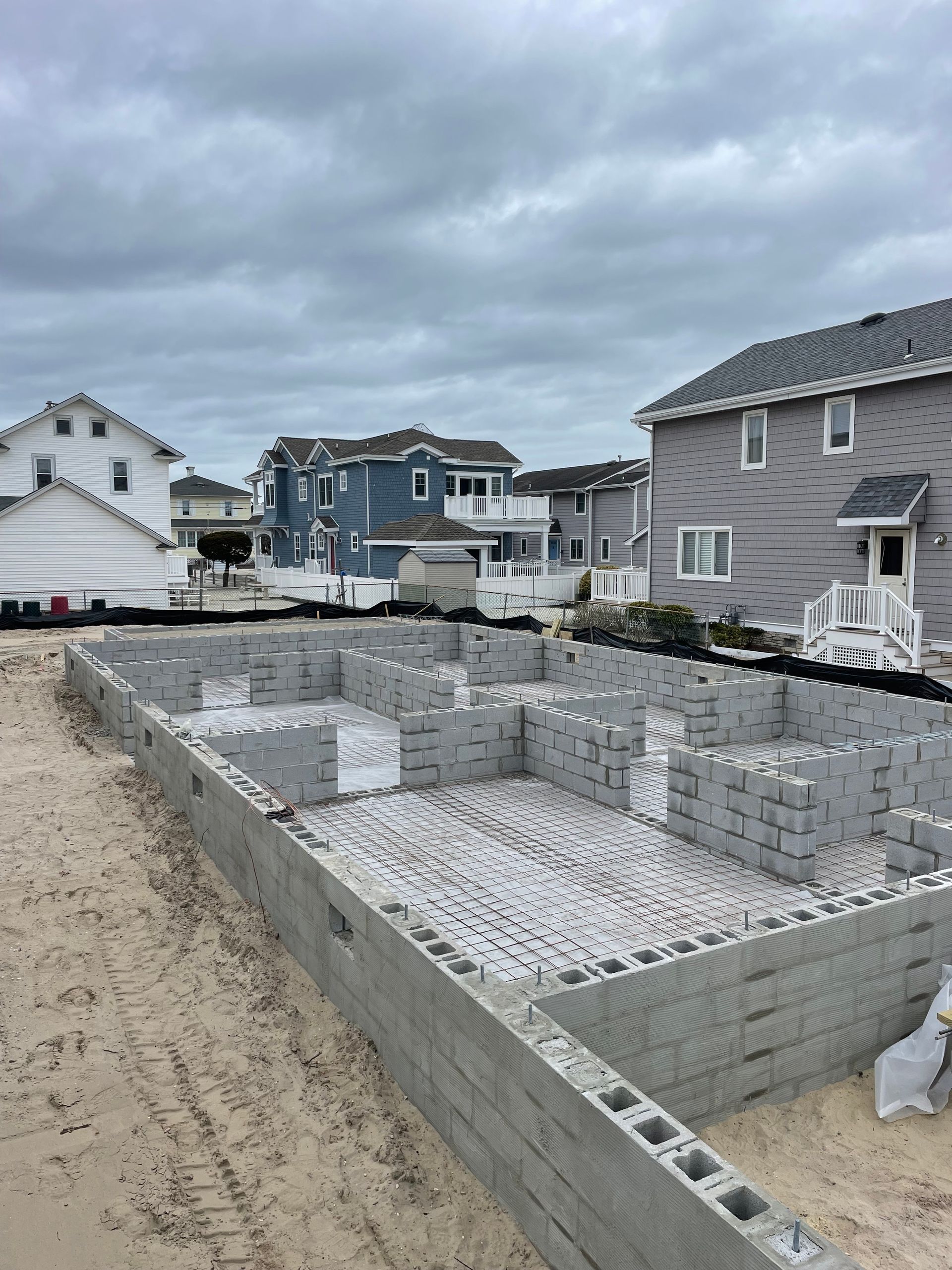 The foundation of a house is being built on the beach.