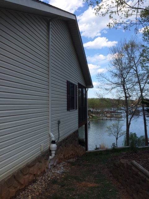 A white house with a view of a lake