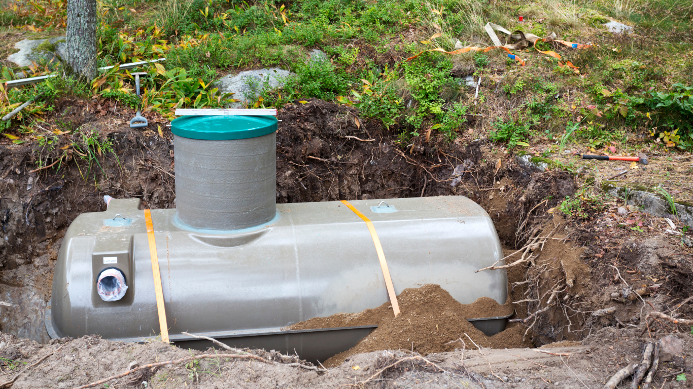 a large tank is sitting in the middle of a dirt field .