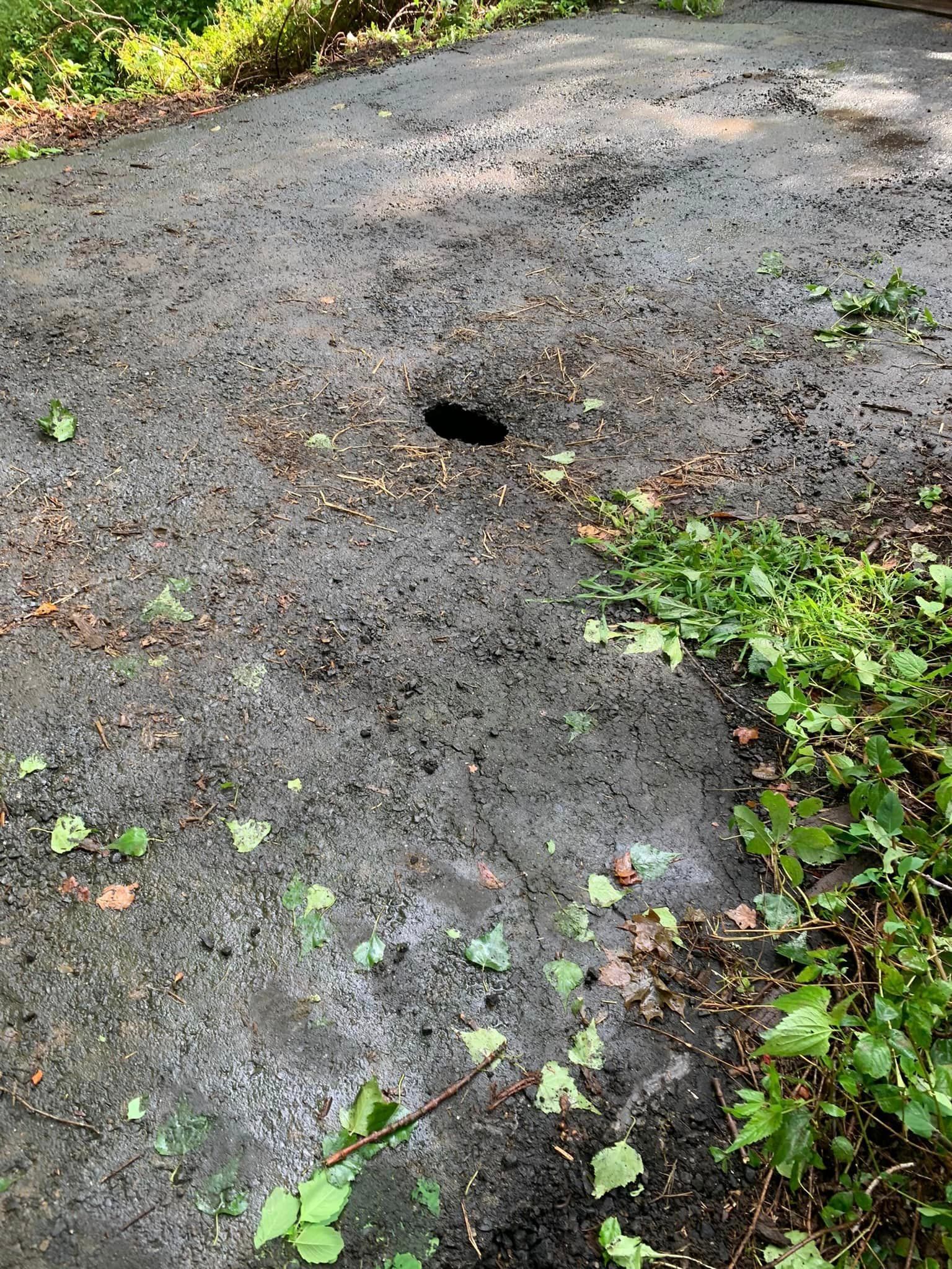 There is a hole in the middle of the road.