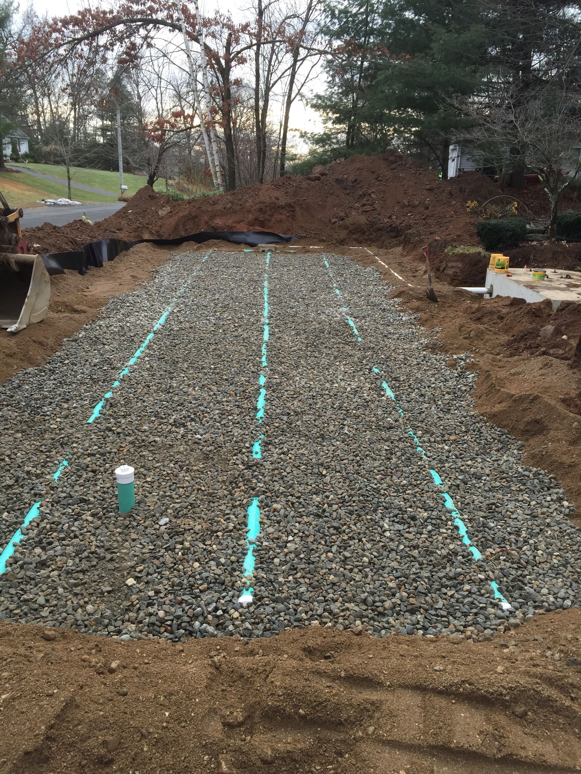 A large pile of gravel with pipes going through it.