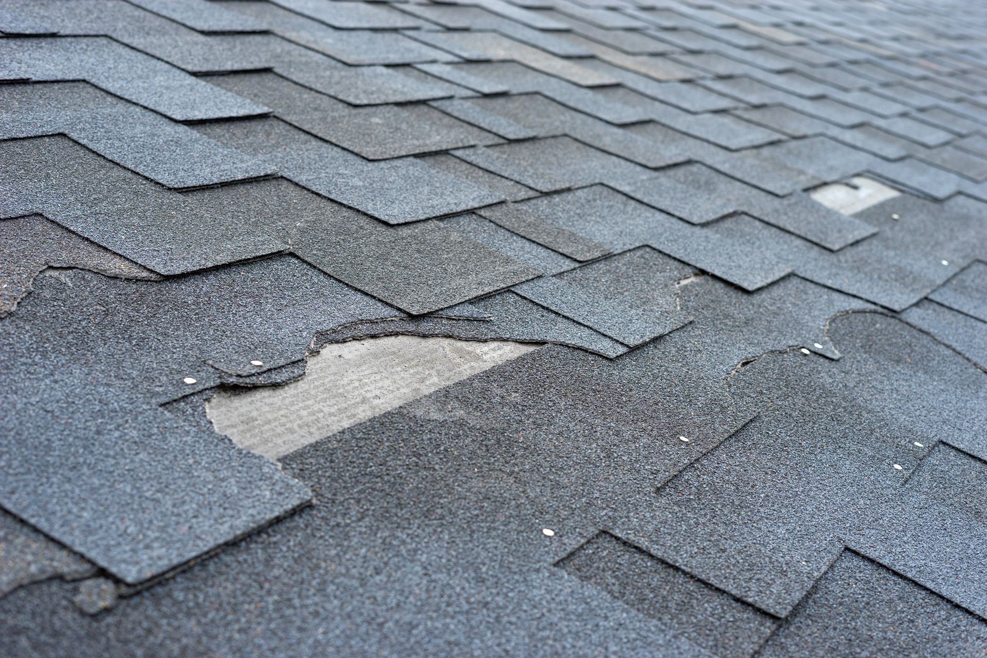 A damaged shingle roof.
