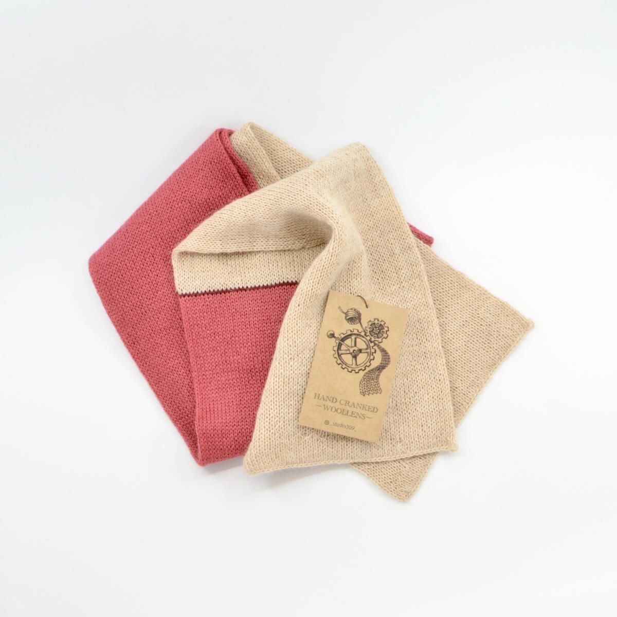 a woollen scarf made from alpaca wool, with one cream coloured end and one pink coloured end