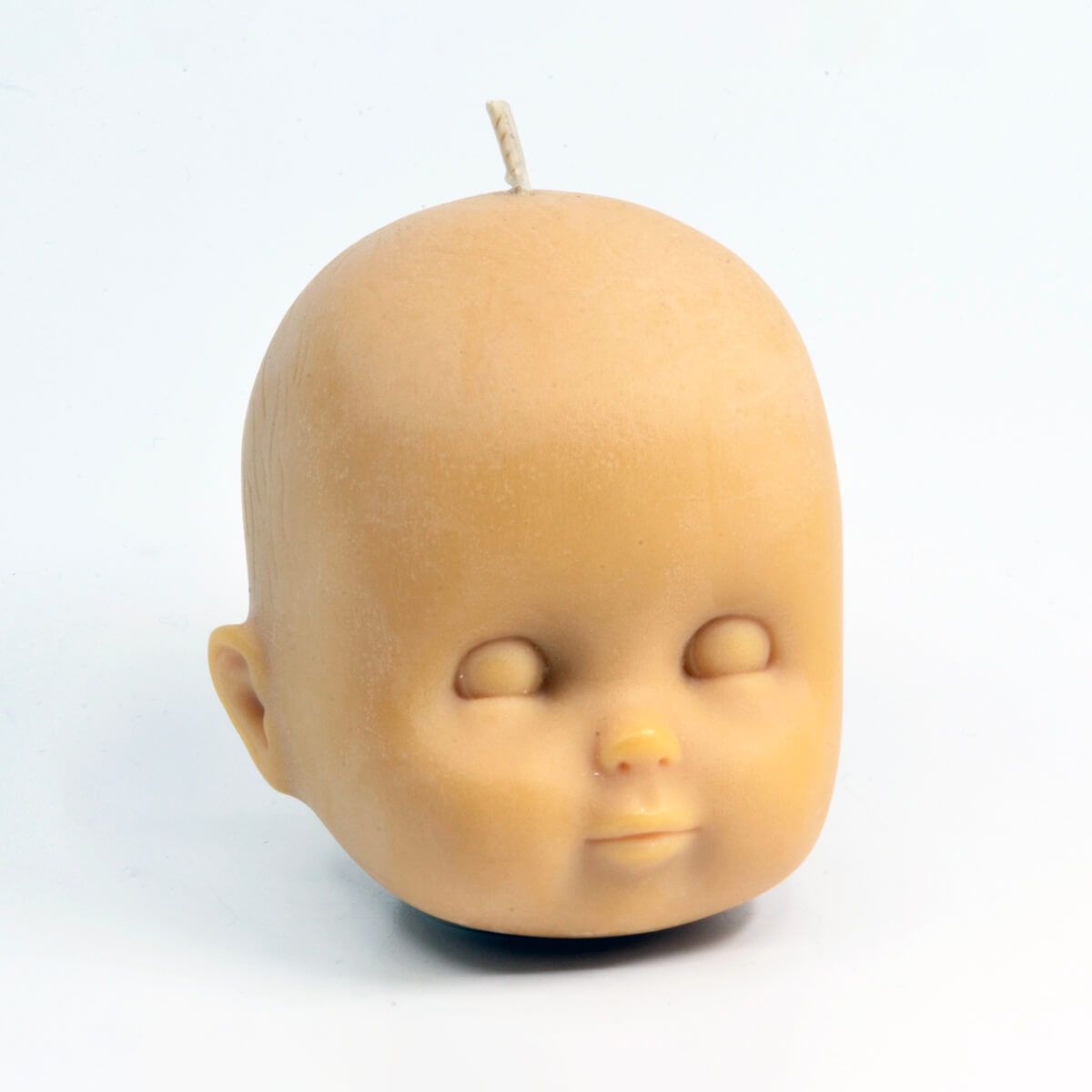 hand-poured candle in the shape of a baby's head, made by You, Me & Bones (Waan Pivasiri)