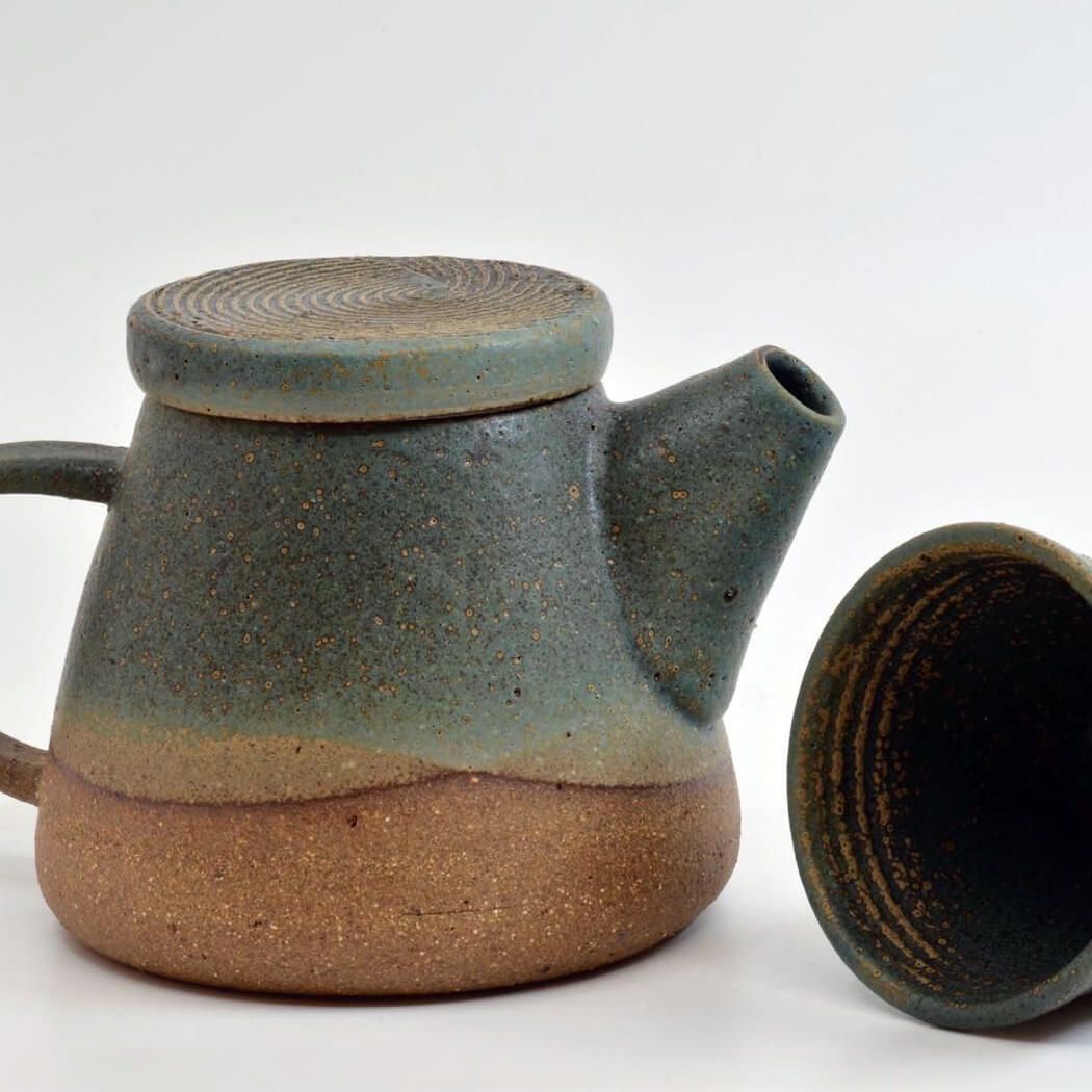 a ceramic teapot and cup with a rough surface finish, made by Sticky Earth