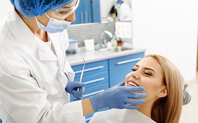 Teeth Extraction — Dentist Checking Patient's Teeth in  New Orleans, LA