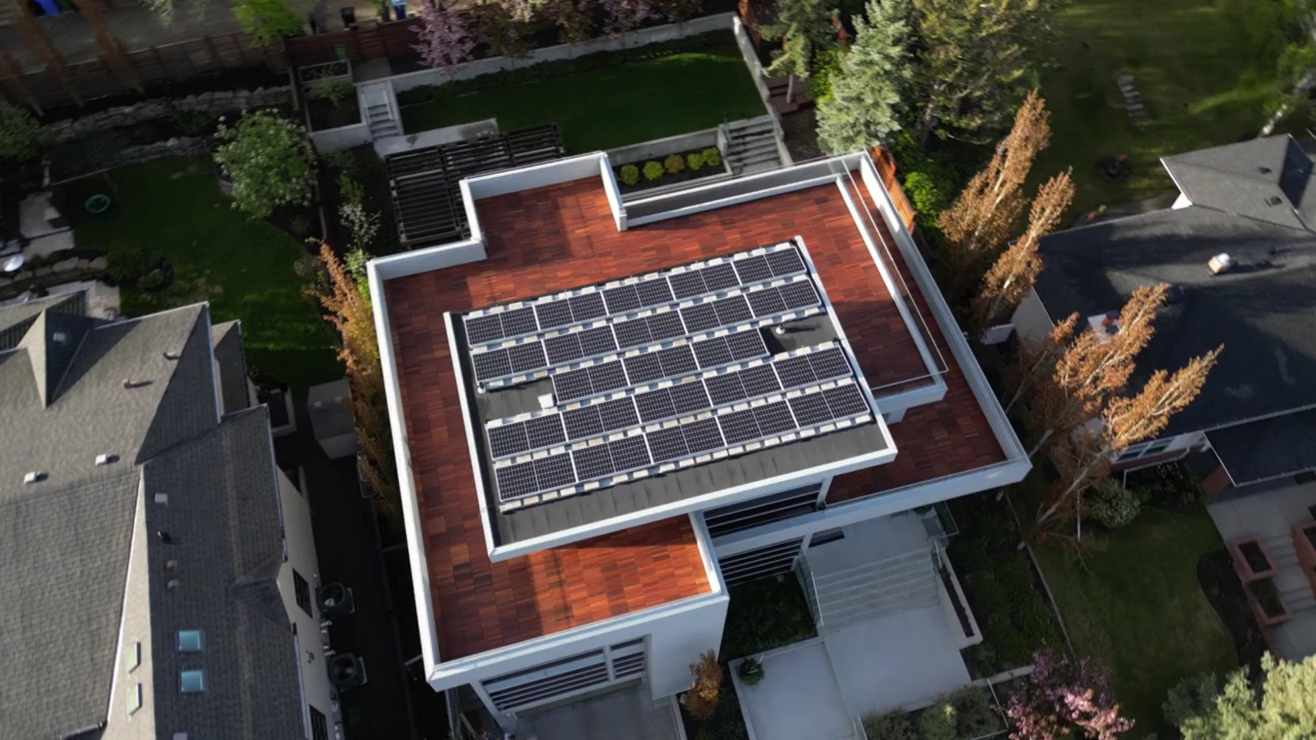 An aerial view of a house with solar panels on the roof