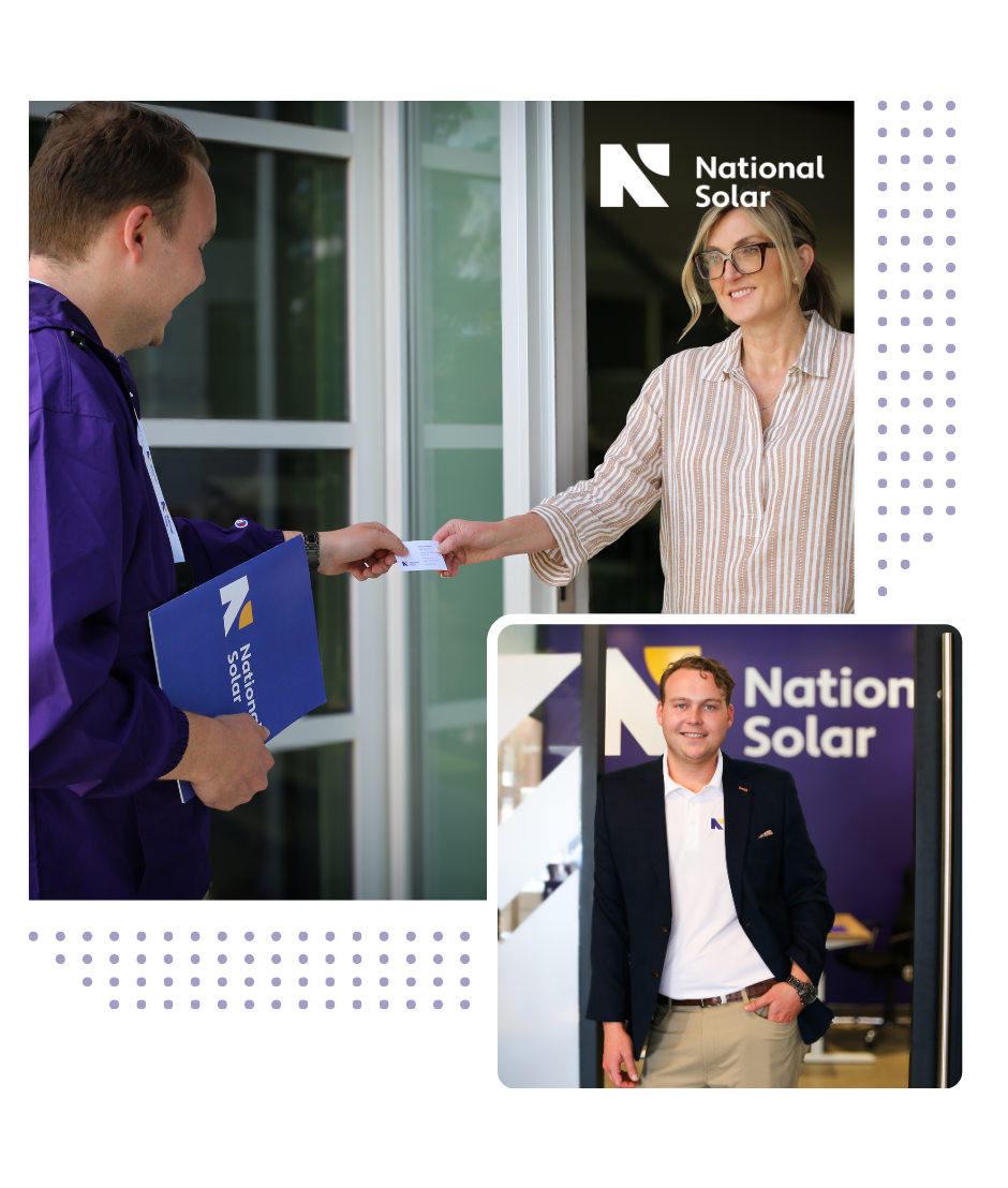 A man is giving a business card to a woman in front of a national solar sign