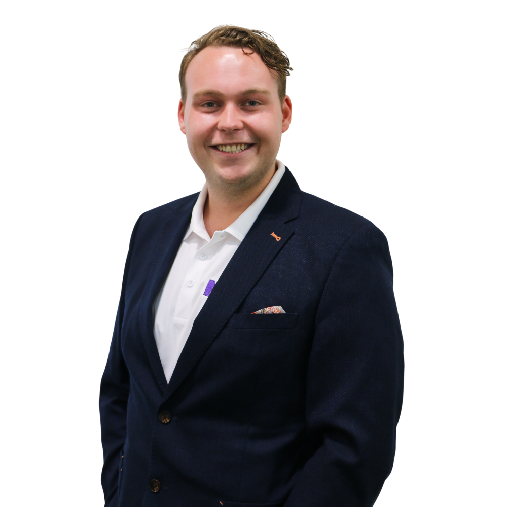 A man in a suit and white shirt is smiling for the camera