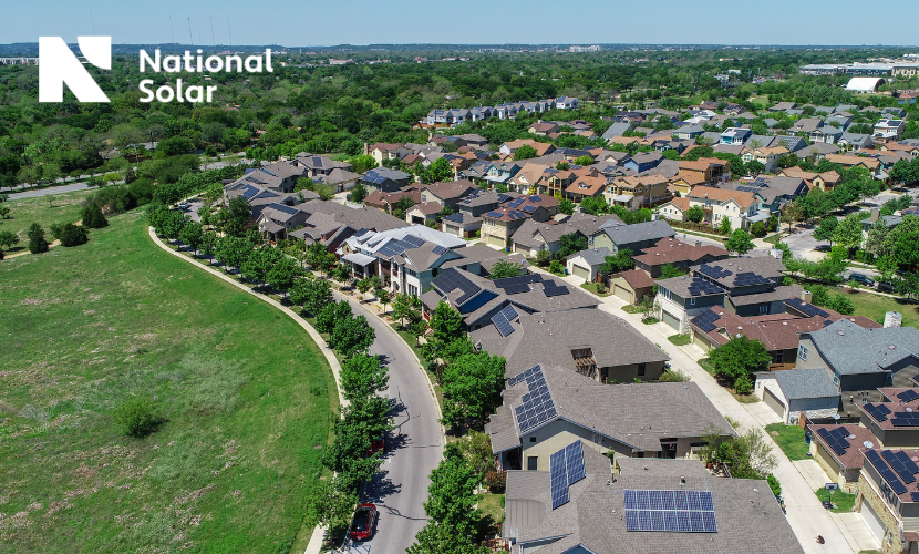 An aerial view of a residential area with a national solar logo in the background