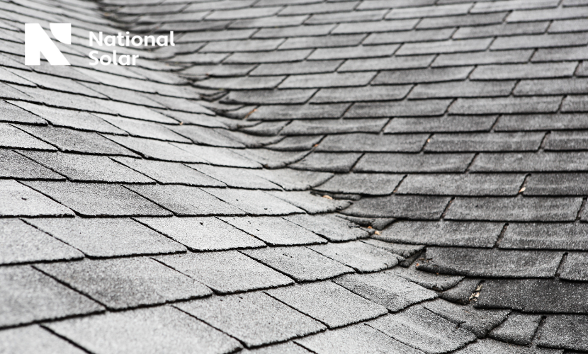 A black and white photo of a roof with a national solar logo in the background.