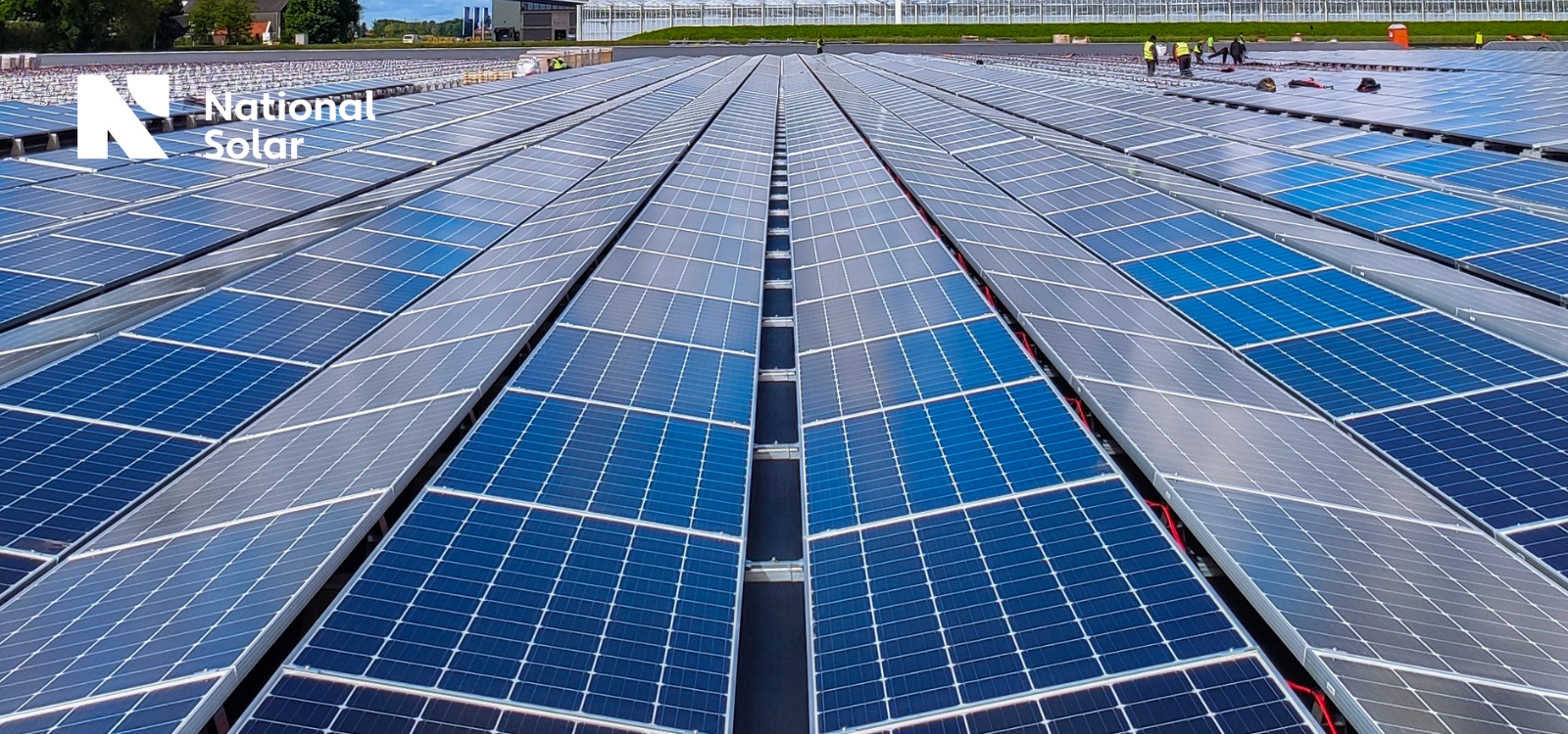 A large amount of solar panels are lined up on a roof