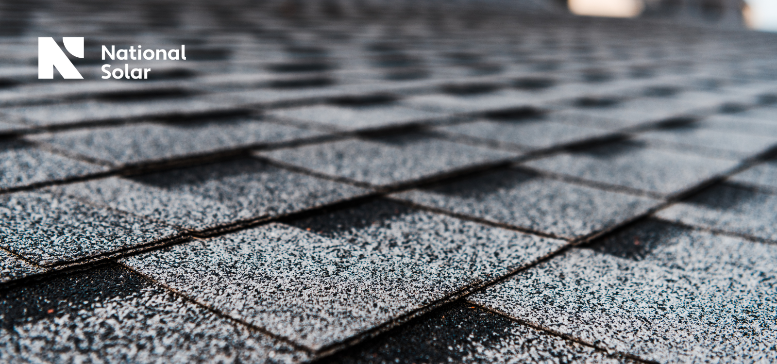 A close up of a roof with national solar in the background