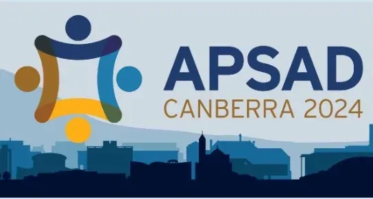 A woman is giving a presentation to a group of people in a conference room.