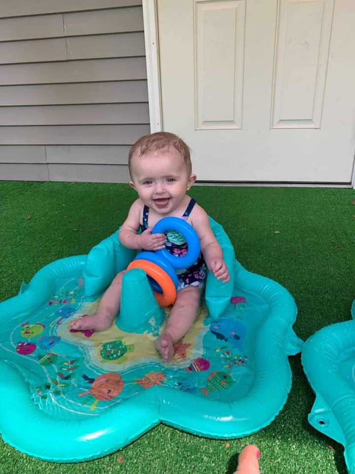 baby on mini water playpen