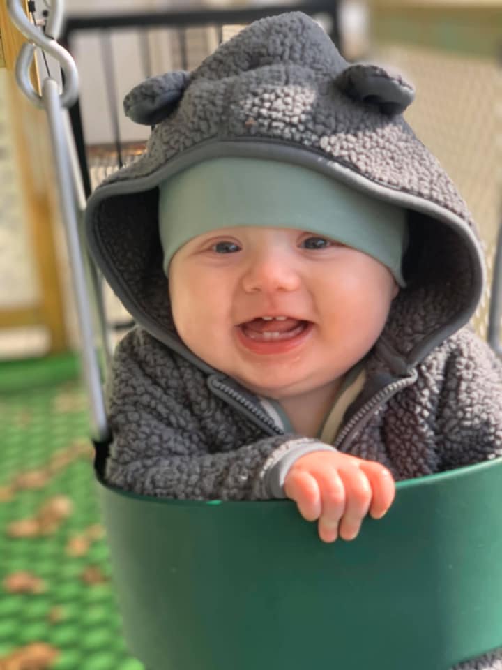 babies with caregiver lying on the floor