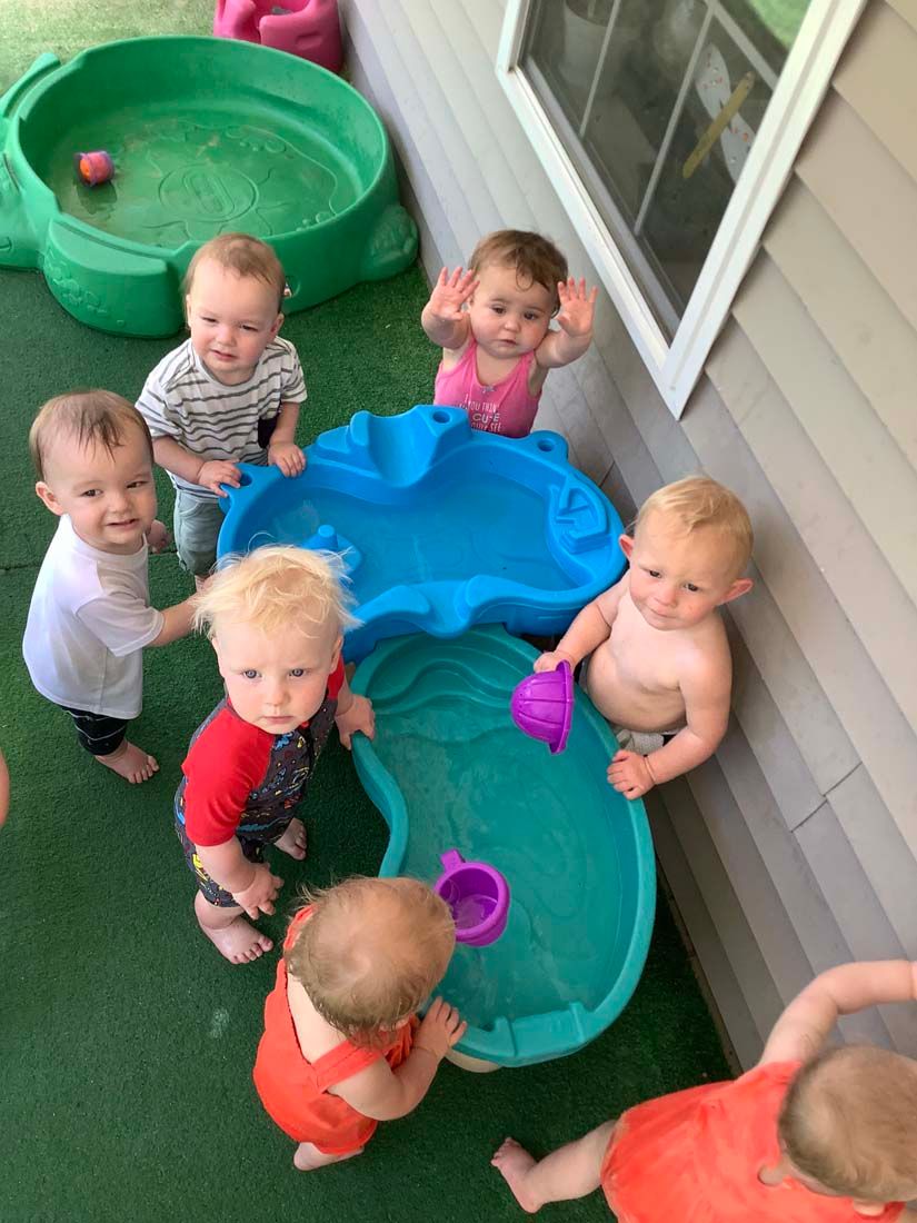 babies playing water on the tub