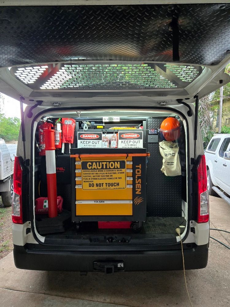 Rear view of a white van with the doors open, revealing organized tools and safety equipment. — Cool Cars NT in Anula, NT