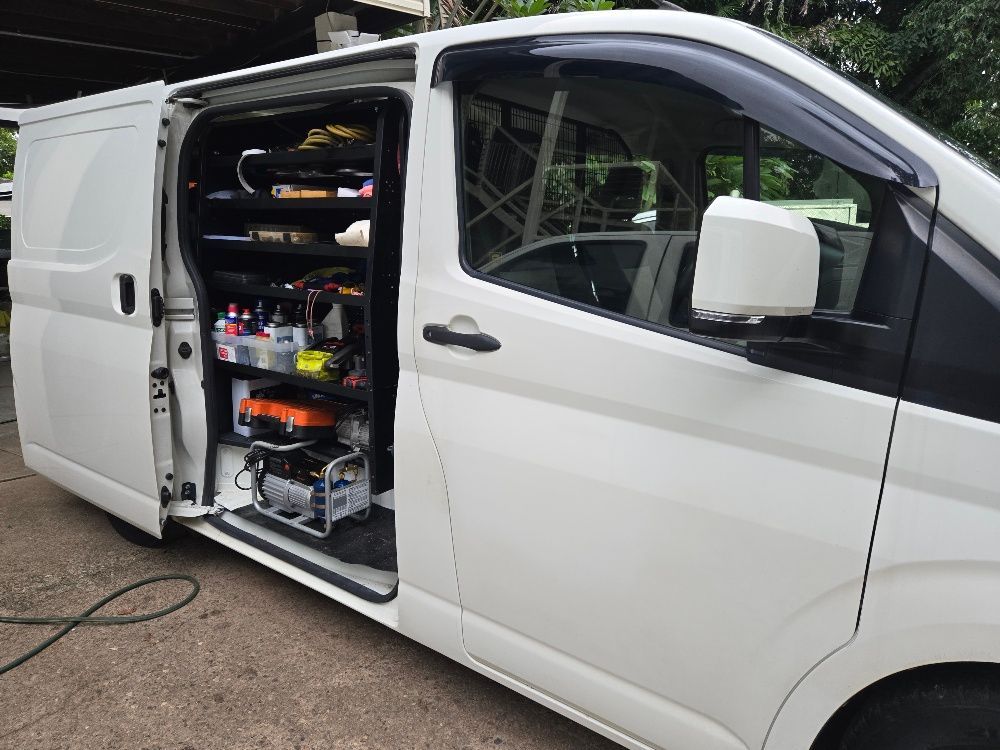 White cargo van with side door open, revealing shelving with tools and equipment. — Cool Cars NT in Anula, NT