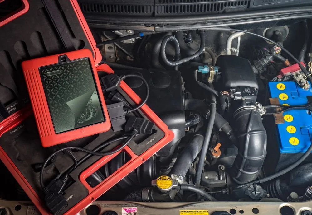 Red Diagnostic Scanner Connected to a Car Engine — Cool Cars NT in Humpty Doo, NT
