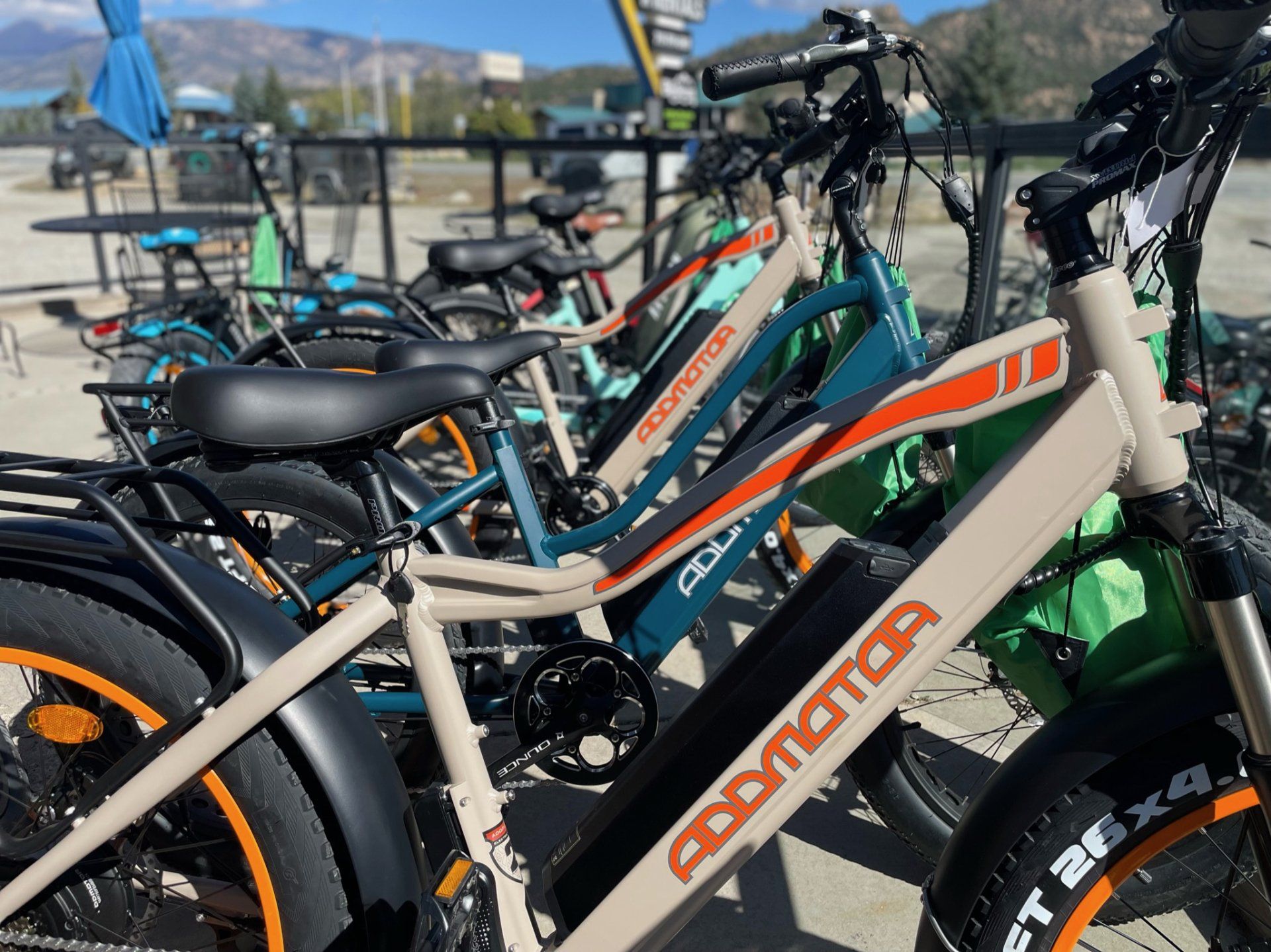 A row of electric bikes are parked next to each other.