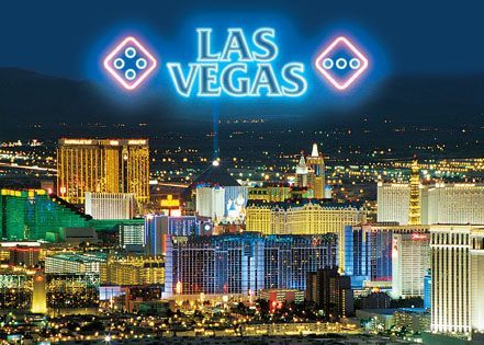 A neon sign that says las vegas over a city